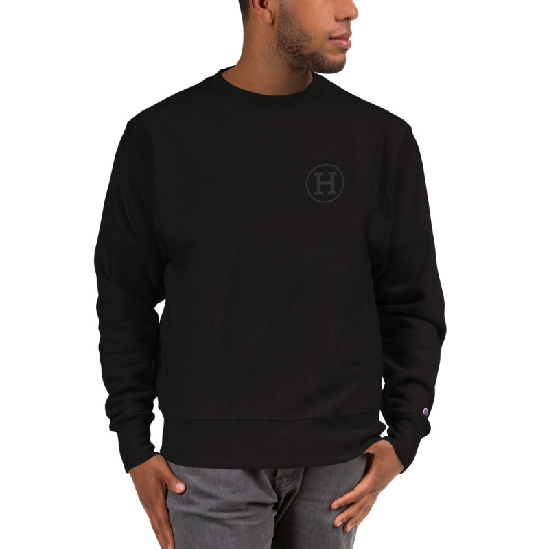 A young man wearing a black champion sweatshirt with the logo for certfied-haters.com printed on the left chest.