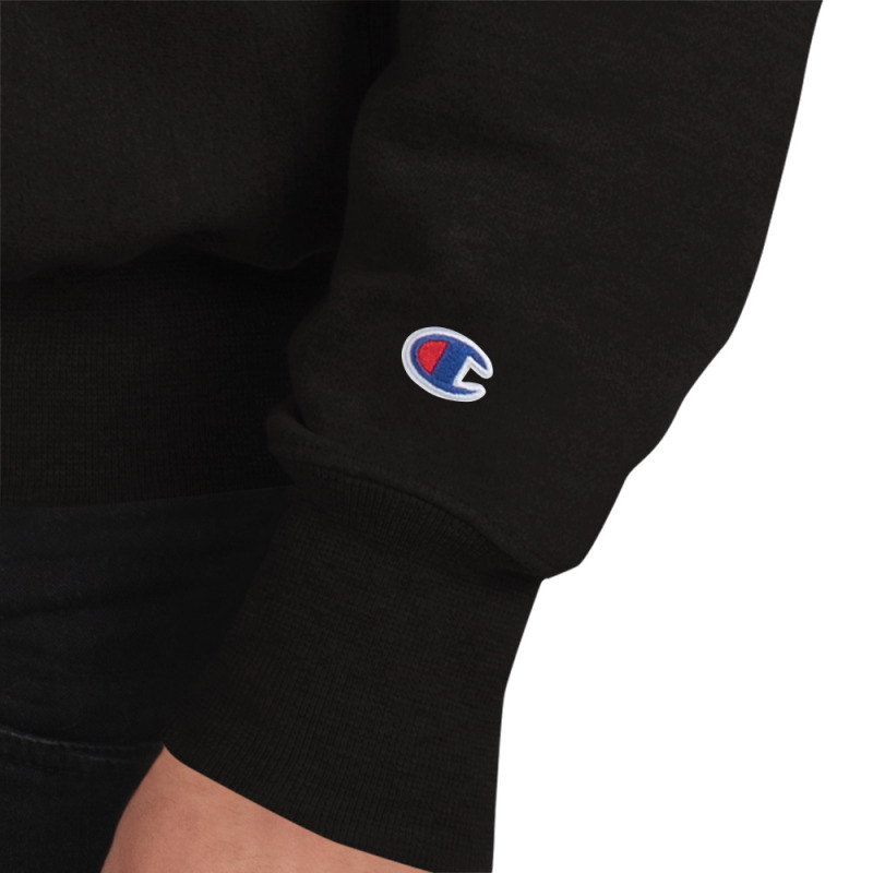 Close up shot of the champion logo on a black sweatshirt.