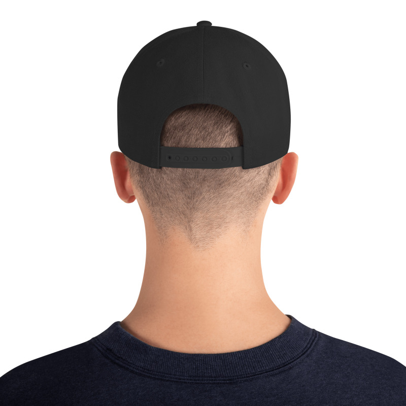 A young man wearing a black snapback hat with the word "Petty" embroidered in black on the front of the hat.